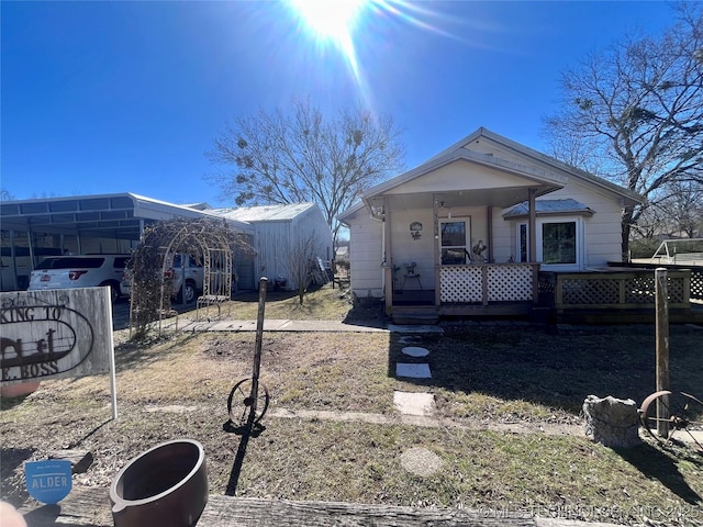 view of front of house featuring covered porch and a carport