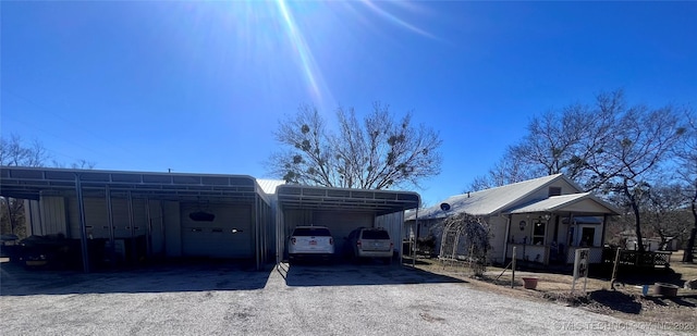 view of car parking featuring driveway and a detached carport