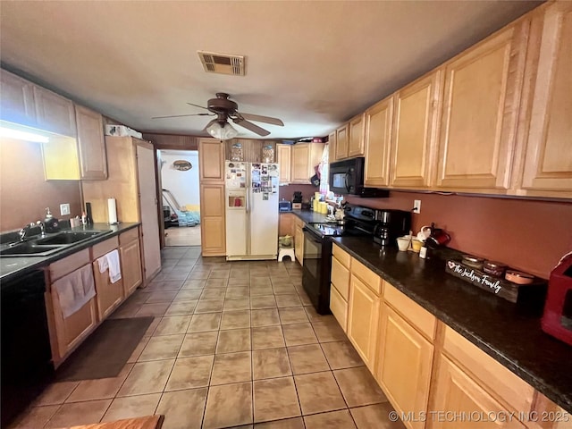 kitchen with light tile patterned floors, visible vents, light brown cabinetry, black appliances, and a sink