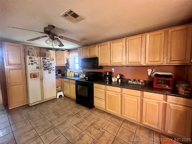 kitchen with black appliances, light brown cabinetry, dark countertops, and visible vents