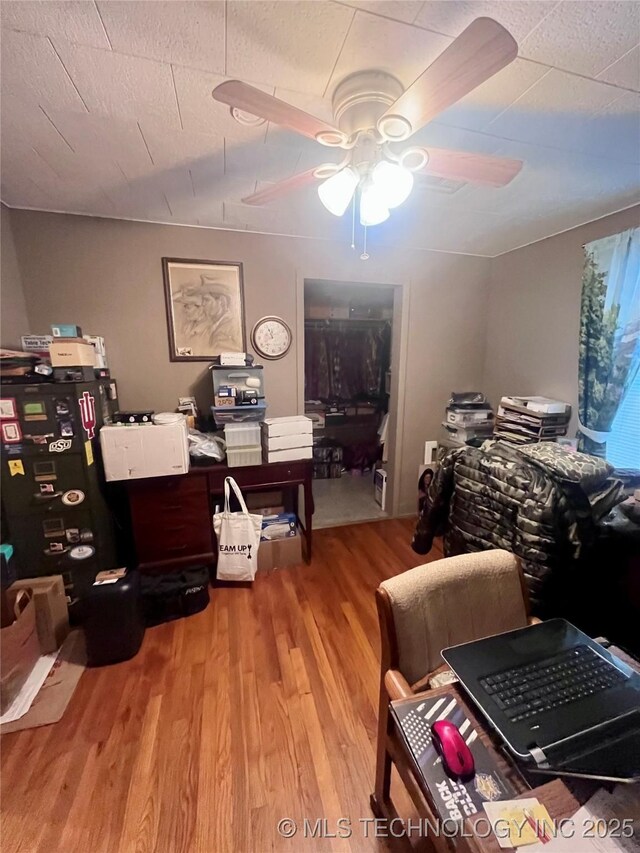 office area with ceiling fan and wood finished floors