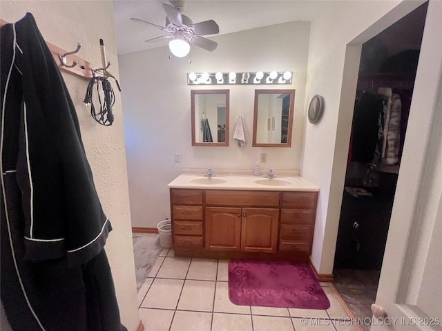 bathroom featuring double vanity, tile patterned flooring, a sink, and a ceiling fan