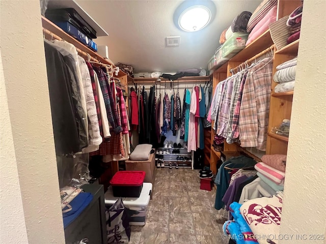 spacious closet featuring visible vents