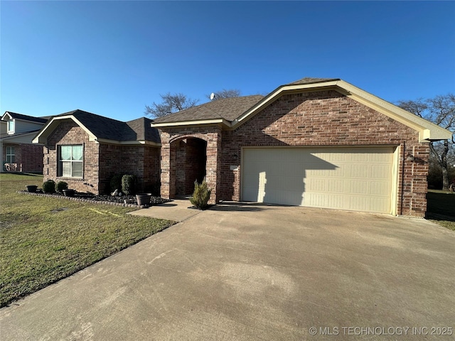 single story home with a front lawn, brick siding, an attached garage, and driveway