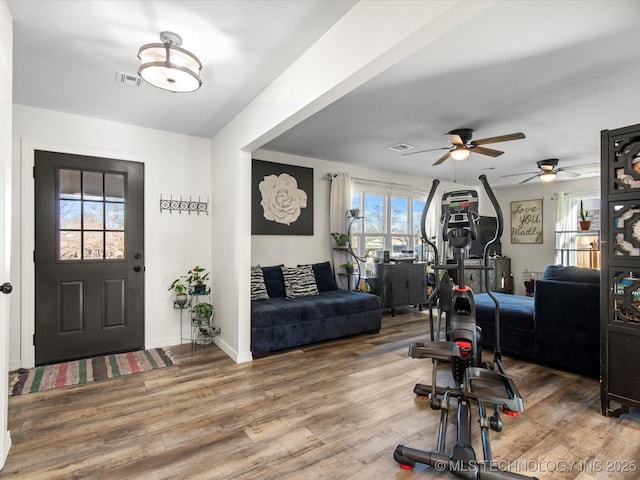 entrance foyer featuring visible vents, baseboards, and wood finished floors