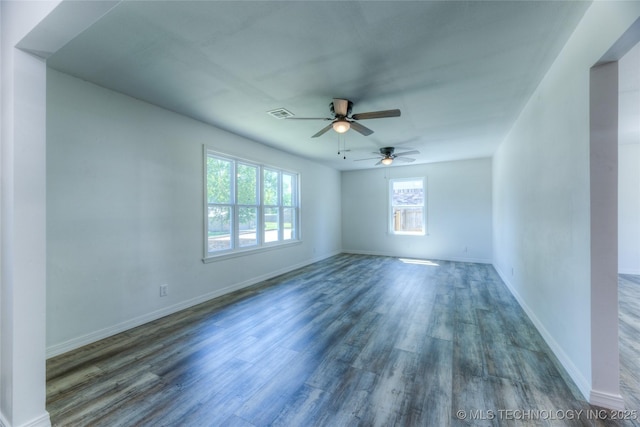 spare room featuring ceiling fan, wood finished floors, visible vents, and baseboards