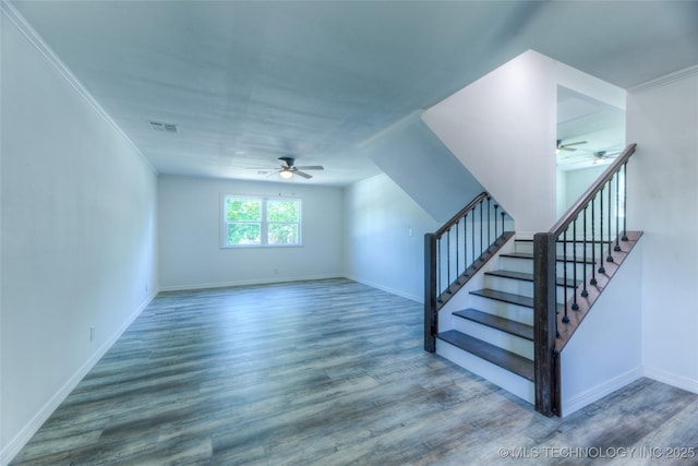 interior space with stairs, wood finished floors, visible vents, and baseboards