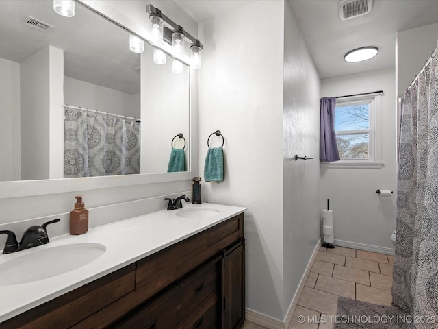 full bathroom with double vanity, a sink, and visible vents