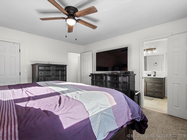 carpeted bedroom featuring ceiling fan and ensuite bathroom