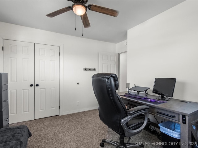 carpeted office featuring ceiling fan and baseboards