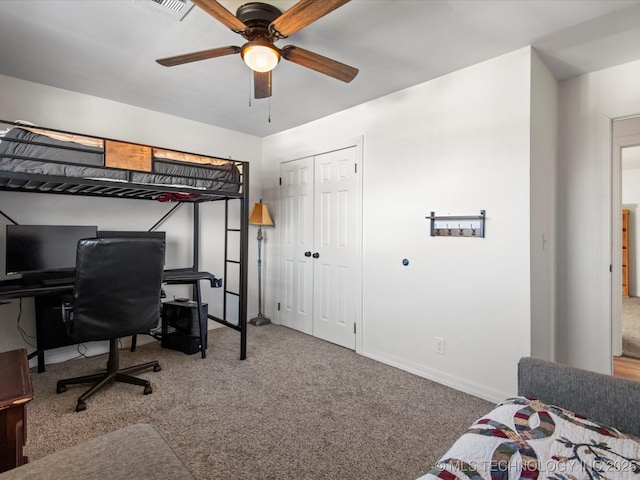 bedroom with a closet, carpet flooring, ceiling fan, and baseboards