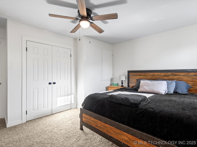 carpeted bedroom featuring a closet and a ceiling fan