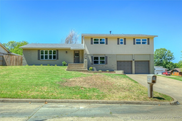 split level home featuring an attached garage, driveway, brick siding, and a front yard