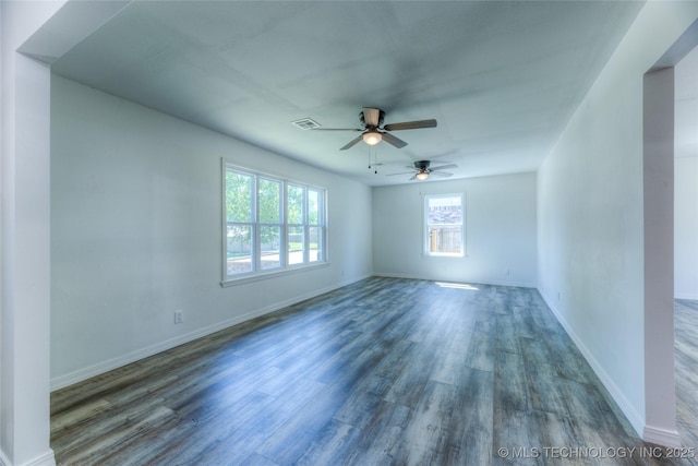 spare room featuring baseboards, a ceiling fan, and wood finished floors