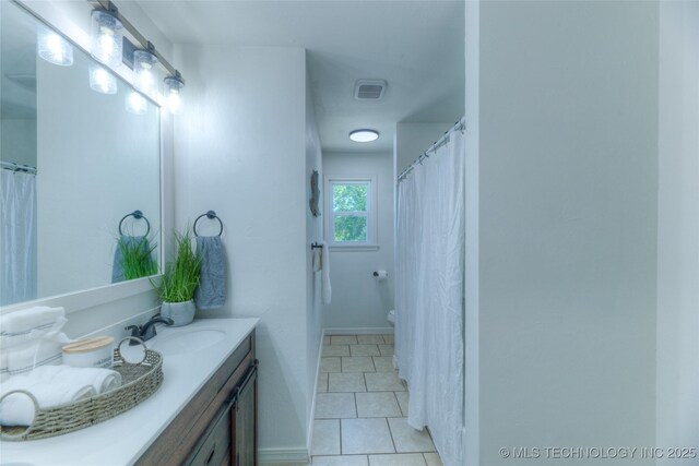 bathroom featuring visible vents, tile patterned flooring, vanity, and toilet