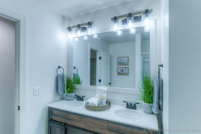 bathroom with a sink and double vanity