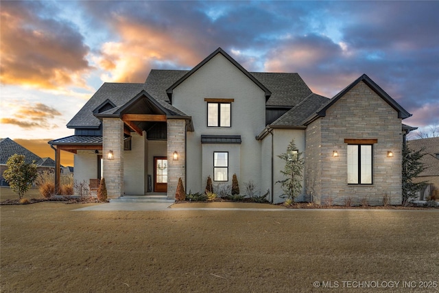 french provincial home with a standing seam roof, a shingled roof, stone siding, and metal roof