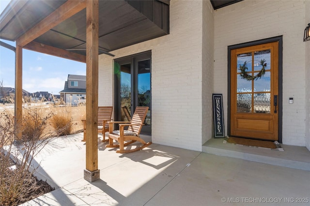 property entrance featuring brick siding