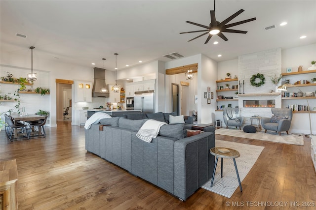 2715 E 136th St S, Bixby, OK 74008 - living area with a ceiling fan, wood finished floors, a fireplace, and recessed lighting