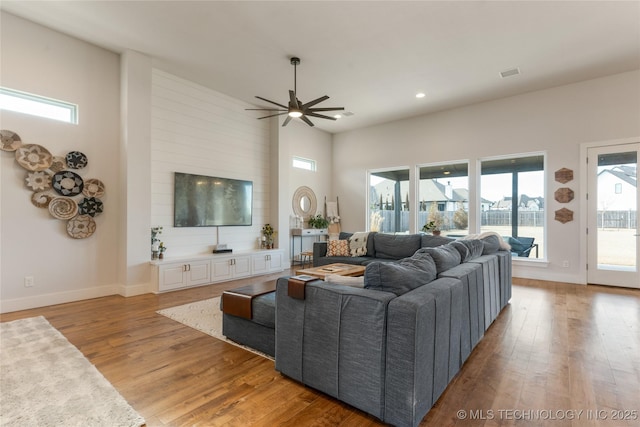 living room with recessed lighting, visible vents, a ceiling fan, light wood-type flooring, and baseboards