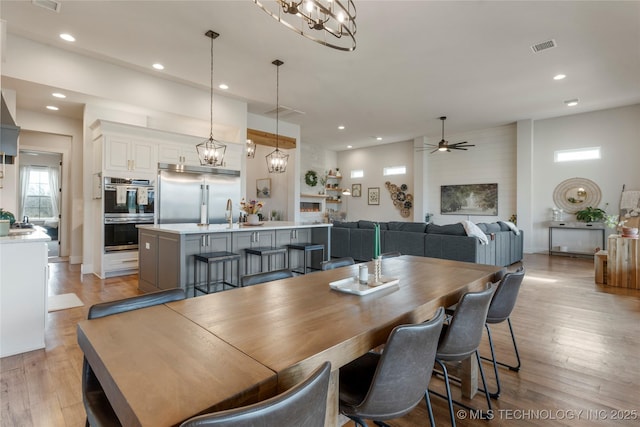 dining area featuring light wood-type flooring, visible vents, and recessed lighting