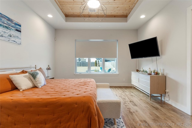 bedroom featuring wooden ceiling, a raised ceiling, light wood-style floors, and recessed lighting