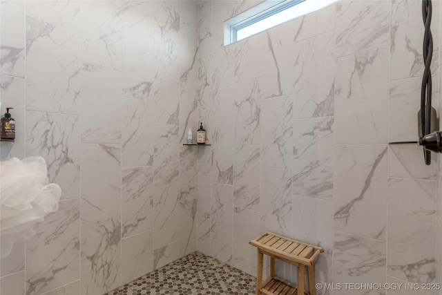 full bath with a tile shower