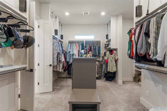 walk in closet featuring light colored carpet and visible vents