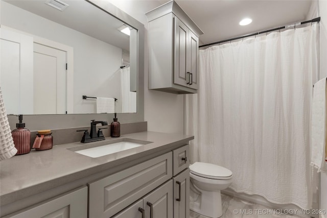 bathroom featuring toilet, recessed lighting, visible vents, and vanity