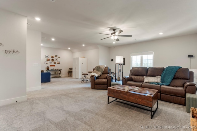 living room featuring baseboards, light colored carpet, a ceiling fan, and recessed lighting