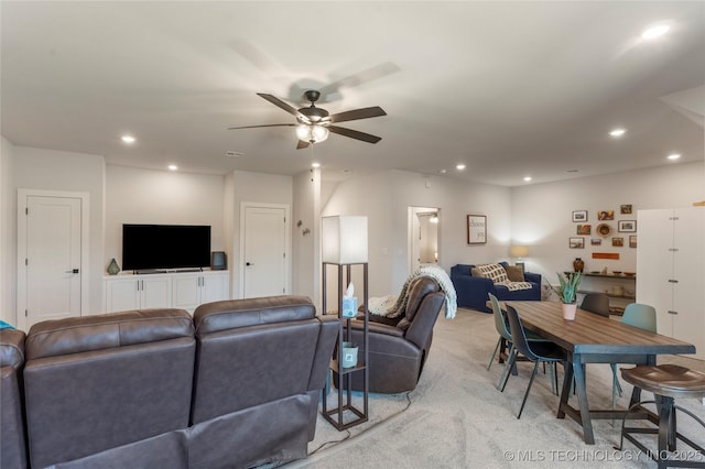 living area featuring recessed lighting, light colored carpet, and ceiling fan