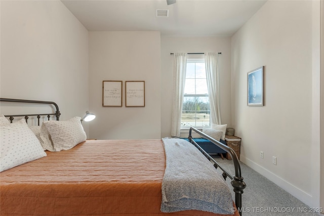 carpeted bedroom with visible vents and baseboards