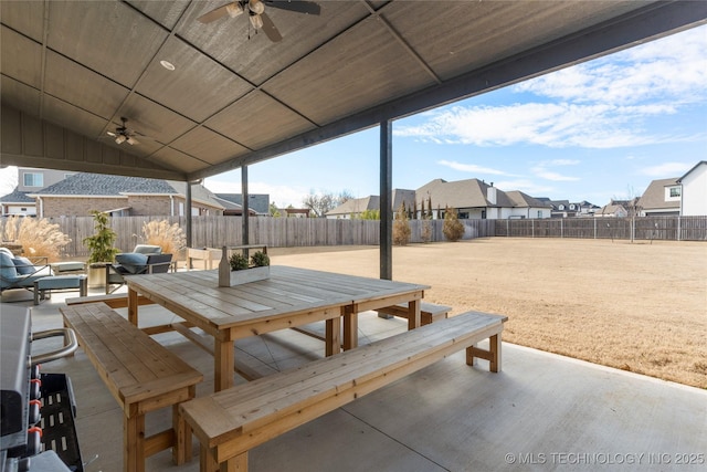 view of patio / terrace featuring outdoor dining space, a residential view, a fenced backyard, and a ceiling fan