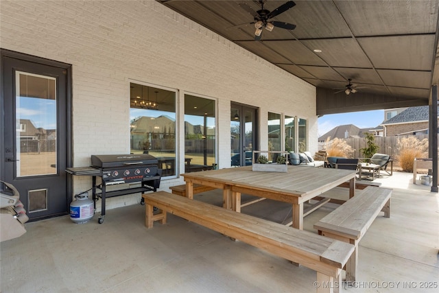 view of patio / terrace with a ceiling fan, a grill, fence, and an outdoor living space