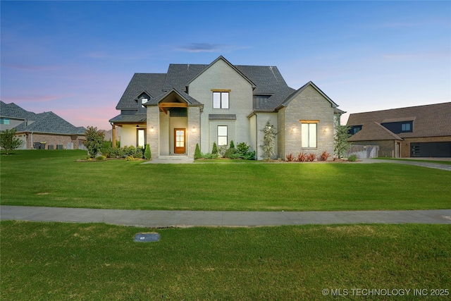 2715 E 136th St S, Bixby, OK 74008 - view of front of house featuring a front lawn, a standing seam roof, stone siding, roof with shingles, and a metal roof