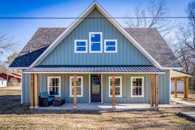 view of front of house featuring covered porch, a shingled roof, metal roof, and board and batten siding