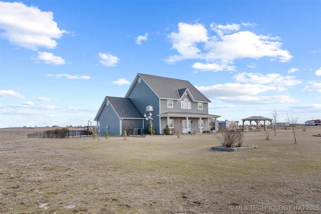 exterior space featuring a front lawn, cooling unit, and a gazebo