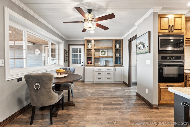 dining space with baseboards, dark wood-type flooring, and crown molding