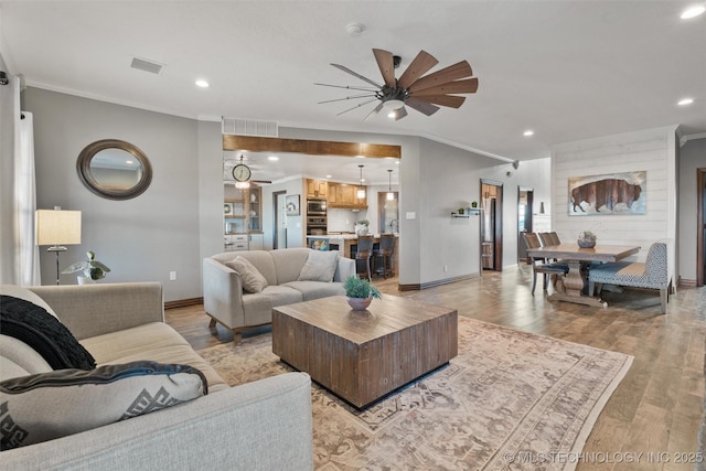 living room featuring crown molding and light wood finished floors