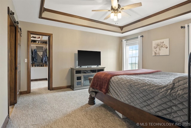 bedroom with carpet, a barn door, a raised ceiling, and crown molding