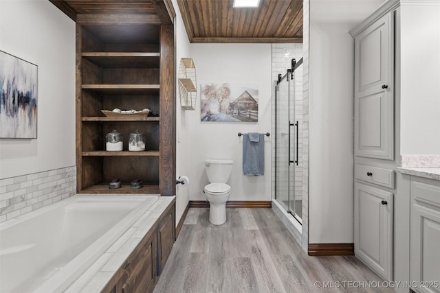 bathroom featuring a garden tub, toilet, a shower stall, wood finished floors, and wooden ceiling