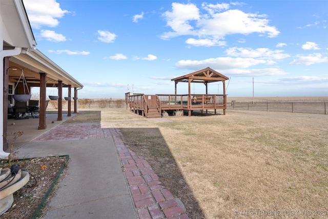 view of yard with a deck, a patio area, and a fenced backyard