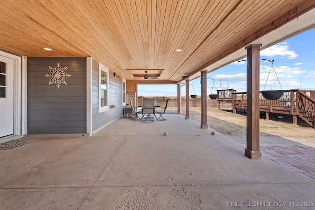 view of patio / terrace with a wooden deck and outdoor dining space