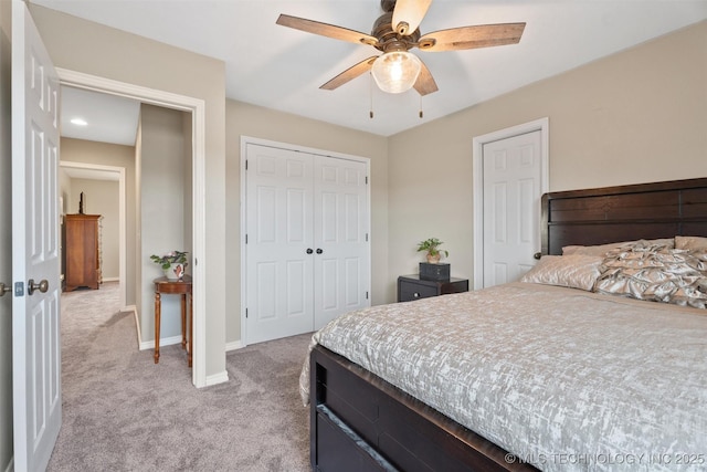 bedroom featuring a closet, light carpet, ceiling fan, and baseboards