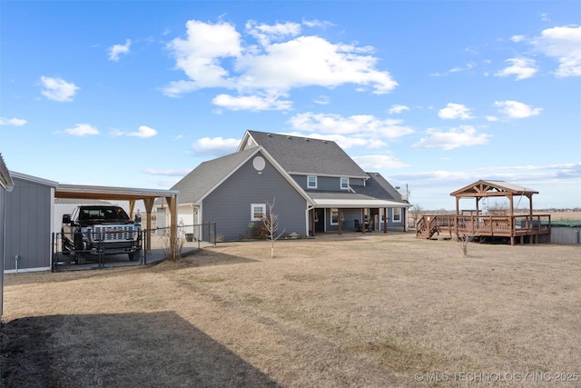 rear view of property with fence