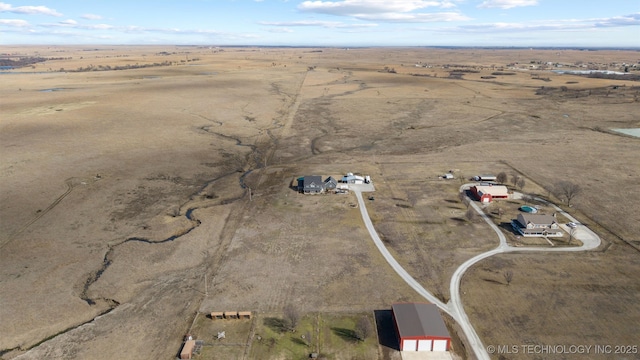birds eye view of property with view of desert and a rural view