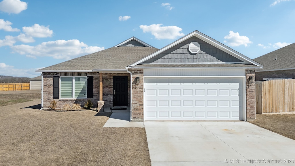 view of front of house with concrete driveway, roof with shingles, an attached garage, fence, and brick siding