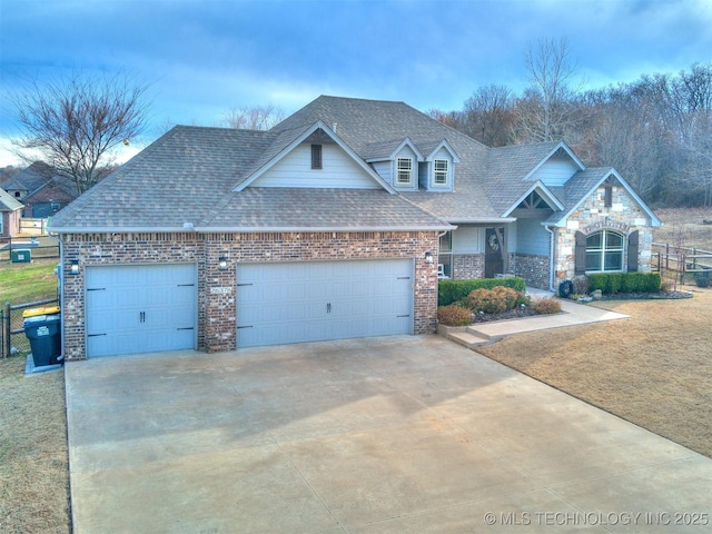 view of front facade with concrete driveway, a shingled roof, an attached garage, and a front yard