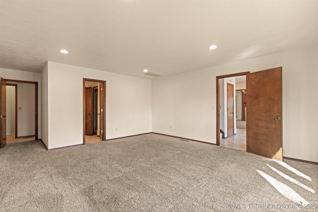 unfurnished room featuring light carpet, baseboards, visible vents, and recessed lighting