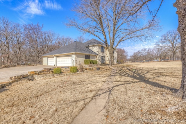 view of side of property with driveway and brick siding